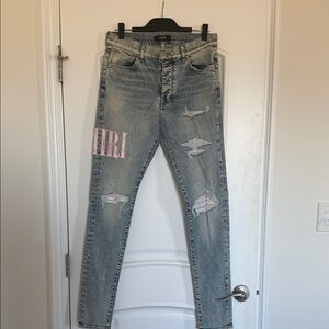 AMIRI Light Blue Distressed Skinny Jeans with Pink Logo